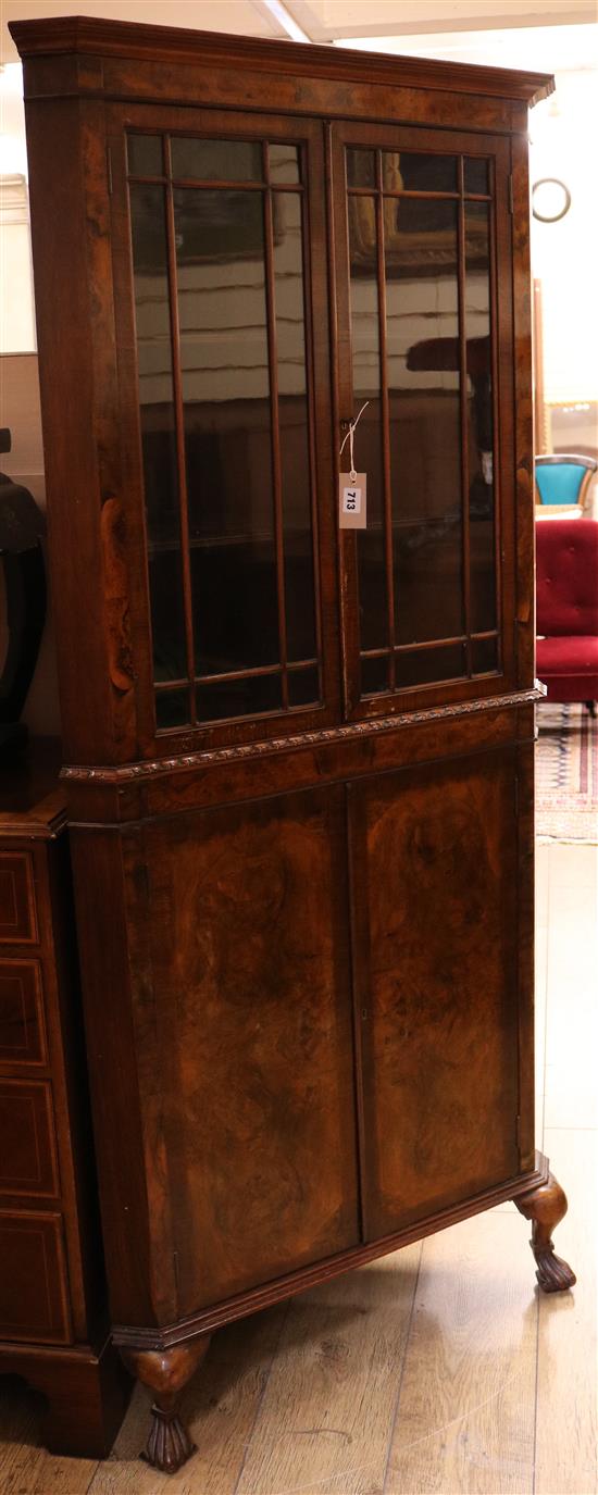 A banded walnut standing corner cupboard W.82cm